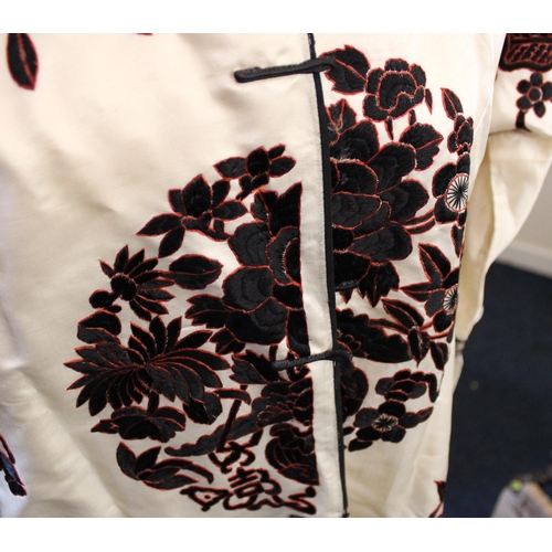 345 - Chinese silk robe, the ivory fabric embroidered with black and red foliate and insect patterns, with... 