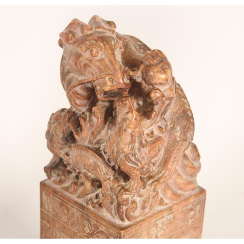 365 - Pair of Chinese carved soapstone table seals, carved on a plinth as Dragons with young, the larger g... 