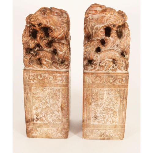 365 - Pair of Chinese carved soapstone table seals, carved on a plinth as Dragons with young, the larger g... 