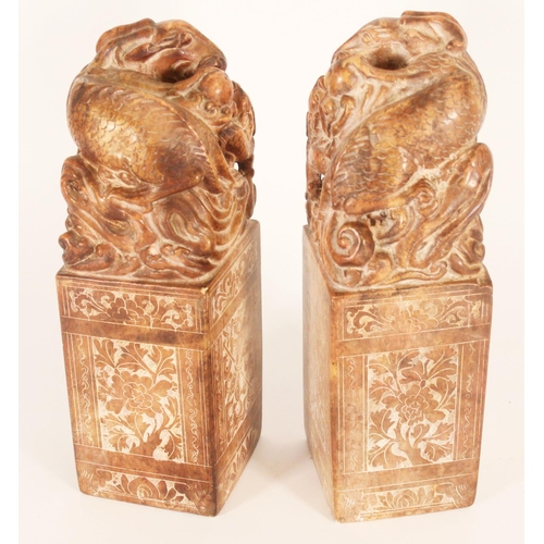 365 - Pair of Chinese carved soapstone table seals, carved on a plinth as Dragons with young, the larger g... 