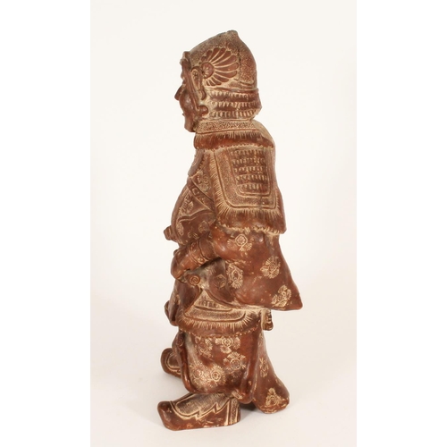 383 - Chinese red clay figure of a warrior in traditional armour, holding a scroll in left hand, H33cm.