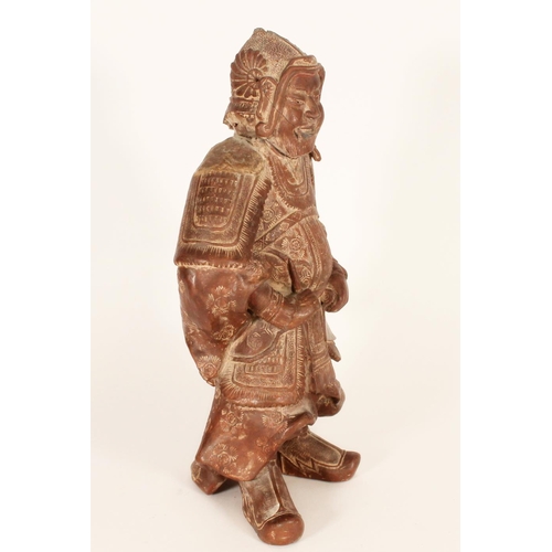 383 - Chinese red clay figure of a warrior in traditional armour, holding a scroll in left hand, H33cm.