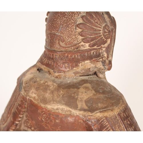 383 - Chinese red clay figure of a warrior in traditional armour, holding a scroll in left hand, H33cm.