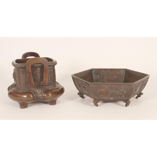 389 - Japanese bronze censer, with looped handles over a dragon and dragon-turtle decorated body, together... 