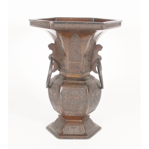 396 - Chinese bronze archaic style vase, of hexagonal form with flared rim and loop handles, decorated wit... 