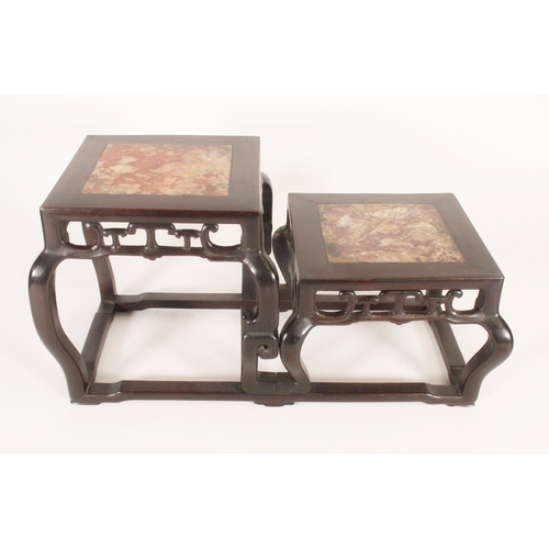 397 - Chinese hardwood two tier stand, the stands inset with mottled marble panels above a pierced apron w... 