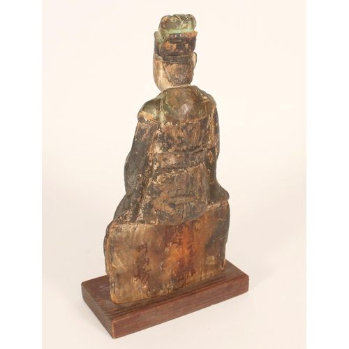 402 - Chinese carved wooden figure of an official, painted in pastel hues, on a wooden pedestal base, H31c... 