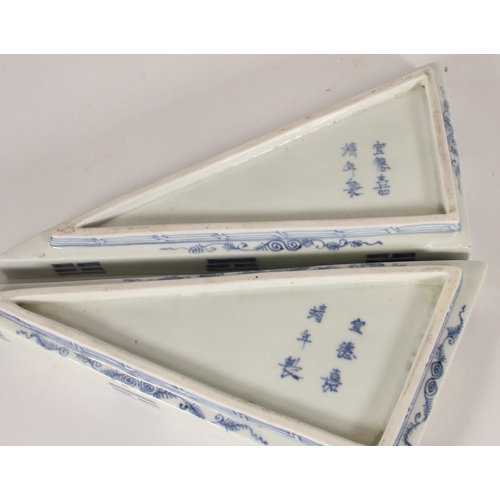 407 - Pair of Japanese Arita blue and white porcelain dishes, of triangle shape with coiled dragon decorat... 