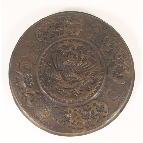 412 - Chinese thin bronze dish, cast in relief with a border of foliate panels framing a central phoenix a... 