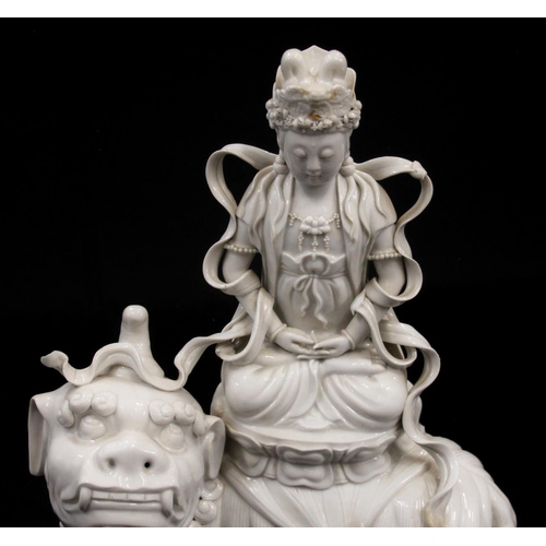 415 - Chinese Blanc de Chine porcelain model of a Boddishattva seated on a Dog of Fo, H42cm.