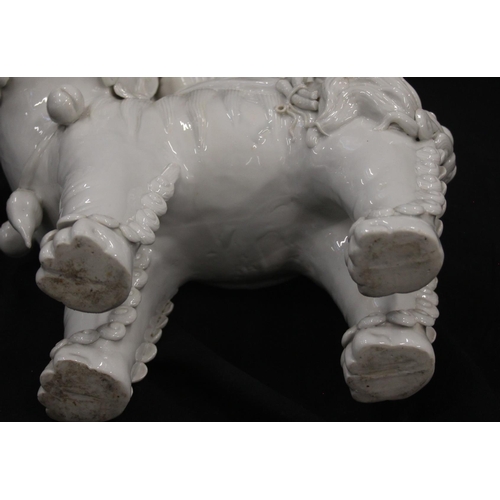 415 - Chinese Blanc de Chine porcelain model of a Boddishattva seated on a Dog of Fo, H42cm.