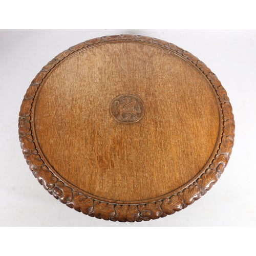 300 - Victorian carved oak revolving Lazy Susan, the plain top with central Welsh dragon, acorn and oak le... 