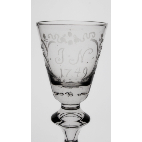 304 - George II baluster wine glass, the round funnel bowl engraved J.N. 1749 within floral frame, the bow... 