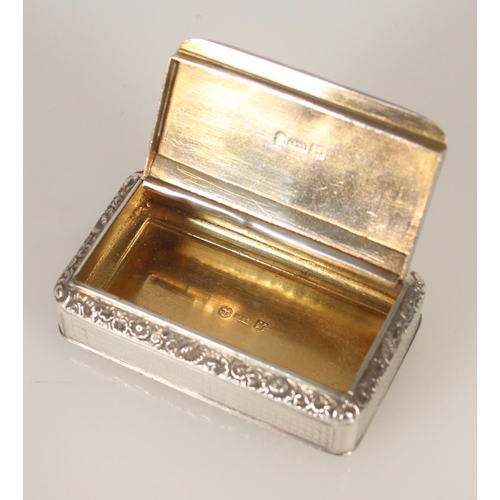 75 - Antique George IV silver snuff box of rectangular form having engine turned decoration and chased fl... 