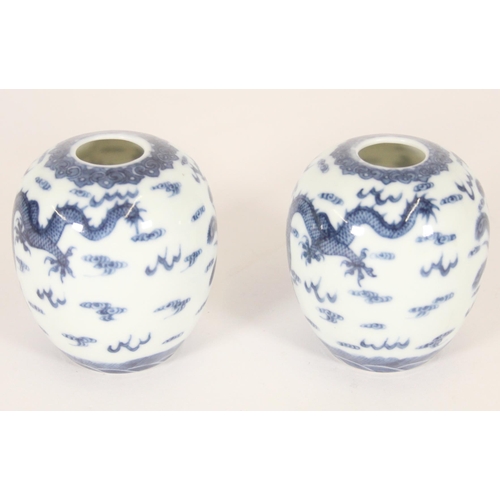 340 - Pair of Chinese porcelain dragon and phoenix vases, late Qing period, the ovoid bodies finely decora... 