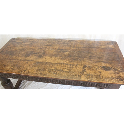 424 - 18th Century oak panel top refectory table, carved skirt above heavy turned column supports, 182cm w... 