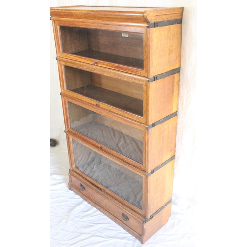 439 - Globe Wernicke of London oak four section bookcase raised on plinth base with single drawer, 86cm wi... 