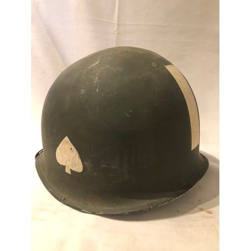 1895 - American WWII style steel helmet with painted decoration in the form of two white spades suggesting ... 