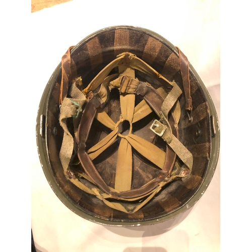 1895 - American WWII style steel helmet with painted decoration in the form of two white spades suggesting ... 