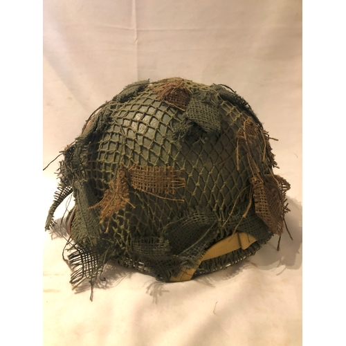 1896 - American M1 style helmet having camouflage cover and netting, Capac liner, with leather headband and... 