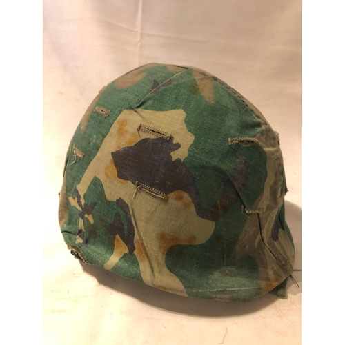 1898 - American M1 style steel helmet having camouflage cover, liner, canvas webbing, and leather headband.