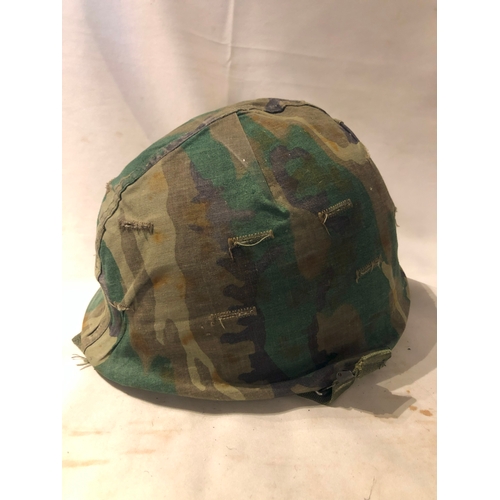 1898 - American M1 style steel helmet having camouflage cover, liner, canvas webbing, and leather headband.