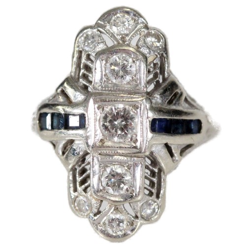 Art Deco style 14ct white gold diamond and sapphire cocktail ring by Dreicer, set with nine round cut diamonds ranging in size from 0.3-0.05cts and six square cut pale blue sapphires, ring size K, 5.8g.