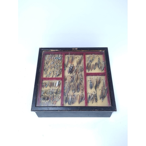 386 - Salmon Flies.  Ebonised glazed case of approximately 115 vintage salmon flies, in two sizes, many wi... 