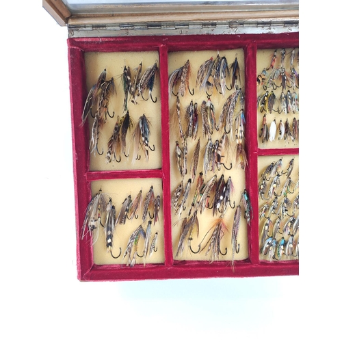 386 - Salmon Flies.  Ebonised glazed case of approximately 115 vintage salmon flies, in two sizes, many wi... 