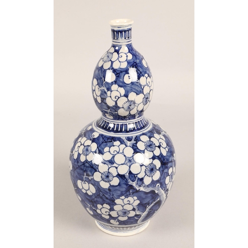 15 - Gourd shaped blue and white oriental vase, 32cm h