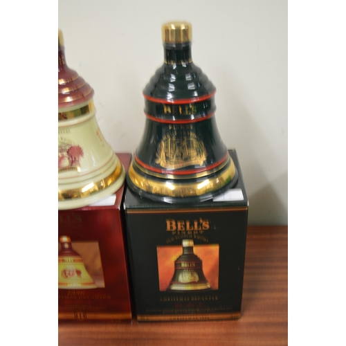 42 - Four Bell's whisky christmas decanters with contents, 1993, 1996, 1997, 1998, 70cl, 40% vol, boxed, ... 