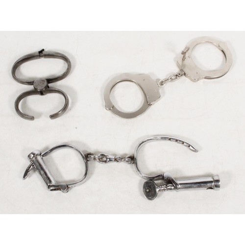 1885 - Pair of Smith & Wesson handcuffs with key, a pair of Hiatt handcuffs with key and another. (3)