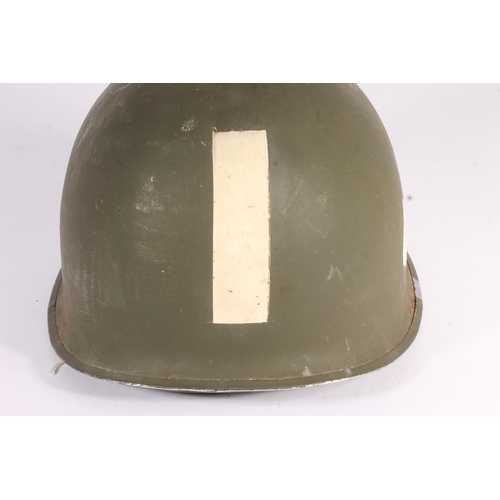 1895 - American WWII style steel helmet with painted decoration in the form of two white spades suggesting ... 