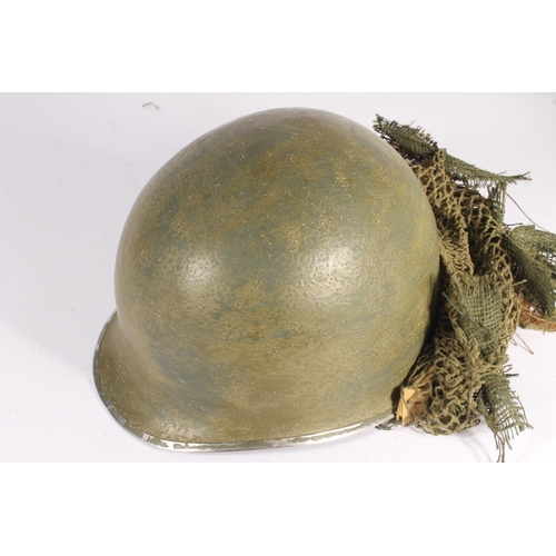 1896 - American M1 style helmet having camouflage cover and netting, Capac liner, with leather headband and... 