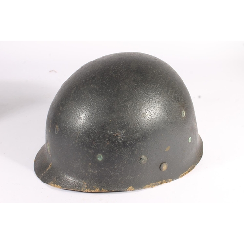 1897 - American M1 style steel helmet having camouflage cover, canvas webbing, the liner marked 'Robert Kuh... 