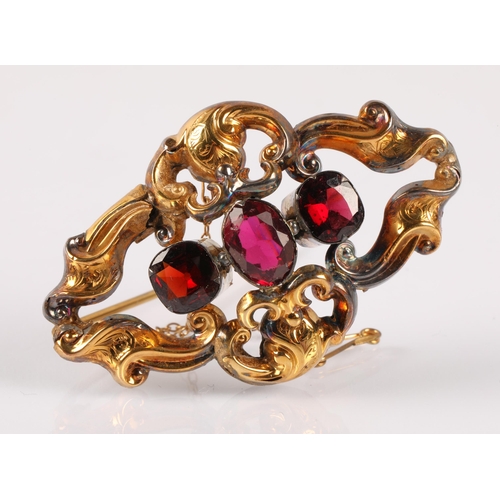 57 - Victorian yellow metal brooch set with three gemstones in shades of pink and orange