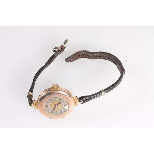 724 - 9ct gold cased ladies wristwatch on antique leather strap.