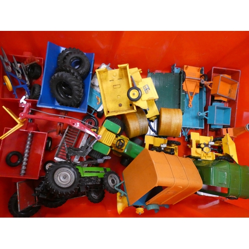 29 - Carton containing diecast and other vehicles to include tractors, farm machinery, plant etc.