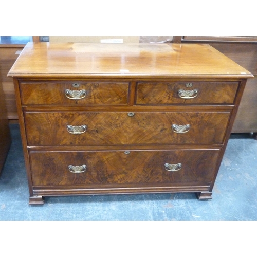 477 - Walnut veneered chest of two short and two long graduated drawers, on squat block feet, 107cm long.