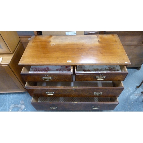 477 - Walnut veneered chest of two short and two long graduated drawers, on squat block feet, 107cm long.