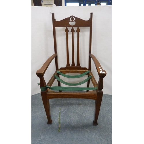 496 - Art Nouveau oak-framed carver armchair with heart-shaped pierced top rail and tulip spars, on square... 