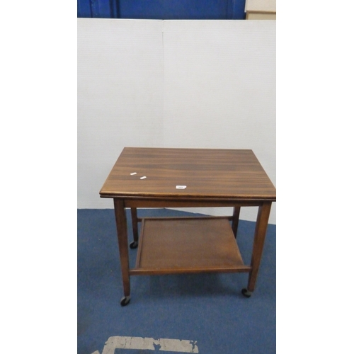 505 - Walnut fold-over tea trolley and a nest of three tables.