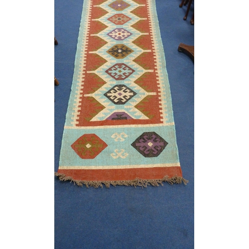 513 - Large Turkish woven hall runner with repeating gul pattern, 730cm x 80cm.