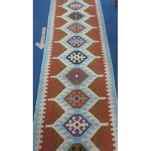 513 - Large Turkish woven hall runner with repeating gul pattern, 730cm x 80cm.