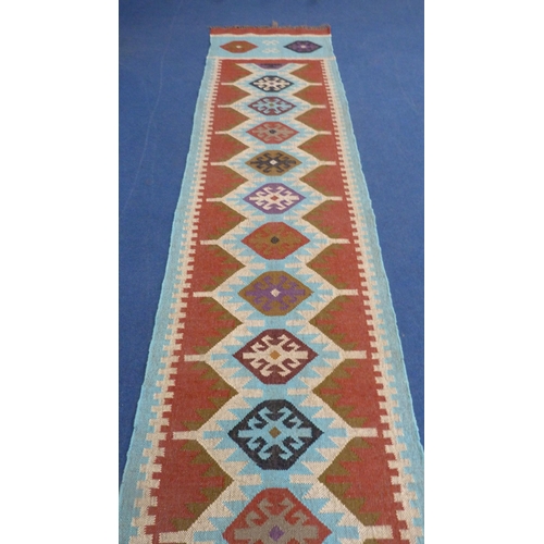 513 - Large Turkish woven hall runner with repeating gul pattern, 730cm x 80cm.