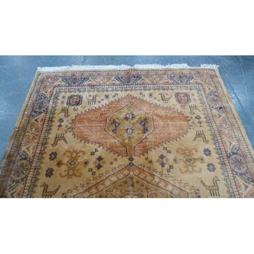 515 - Tabriz style beige ground hand knotted rug decorated with animals, 280cm x 180cm.