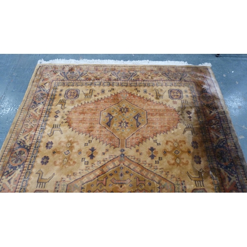 515 - Tabriz style beige ground hand knotted rug decorated with animals, 280cm x 180cm.