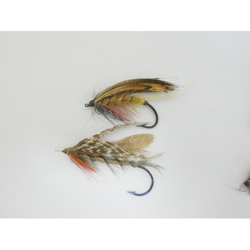 386 - Salmon Flies.  Ebonised glazed case of approximately 115 vintage salmon flies, in two sizes, many wi... 