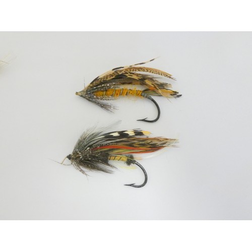 386 - Salmon Flies.  Ebonised glazed case of approximately 115 vintage salmon flies, in two sizes, many wi... 