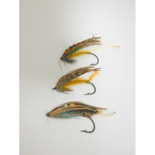 386 - Salmon Flies.  Ebonised glazed case of approximately 115 vintage salmon flies, in two sizes, many wi... 